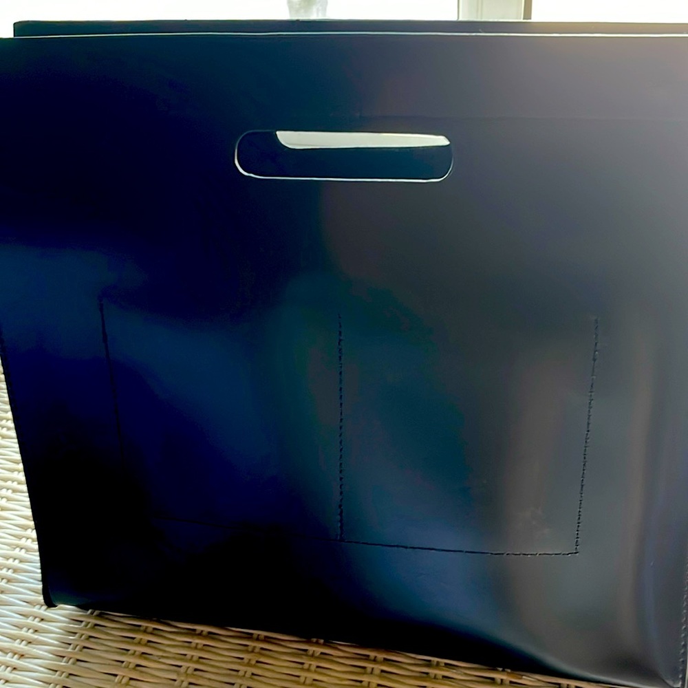 Small black with snaps in the inside and strap.  Brand new. Pockets on inside